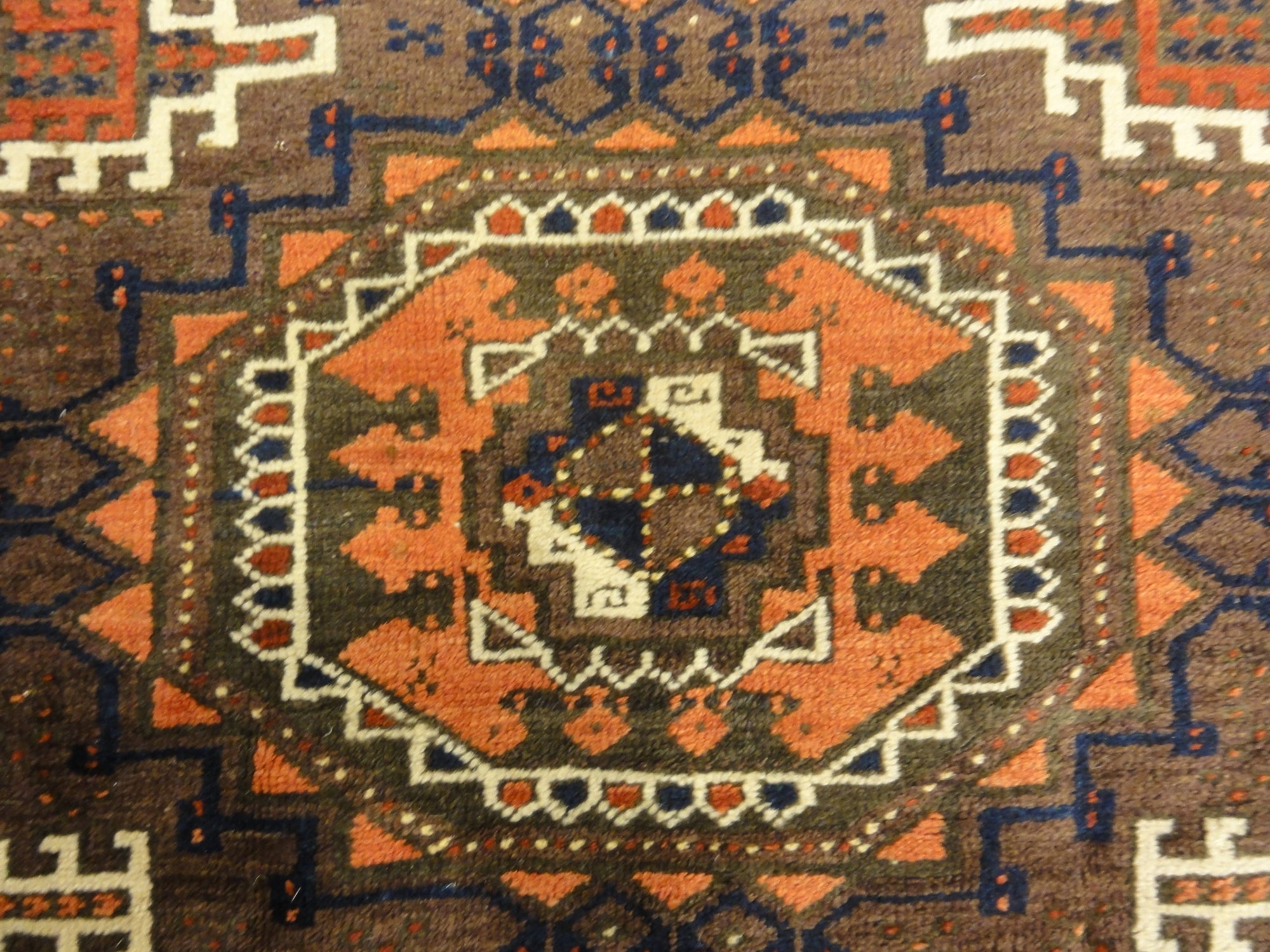 Antique Original Baluch with 3 Medallions and Unique Knotted Ends. An Afghan piece of original genuine woven carpet art sold by Santa Barbara Design Center.